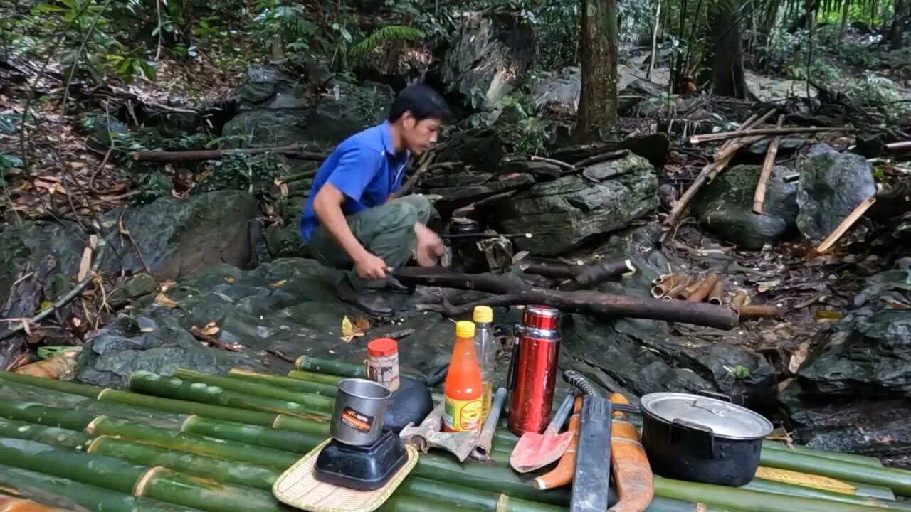 Building a bamboo shelter on a rock face:4