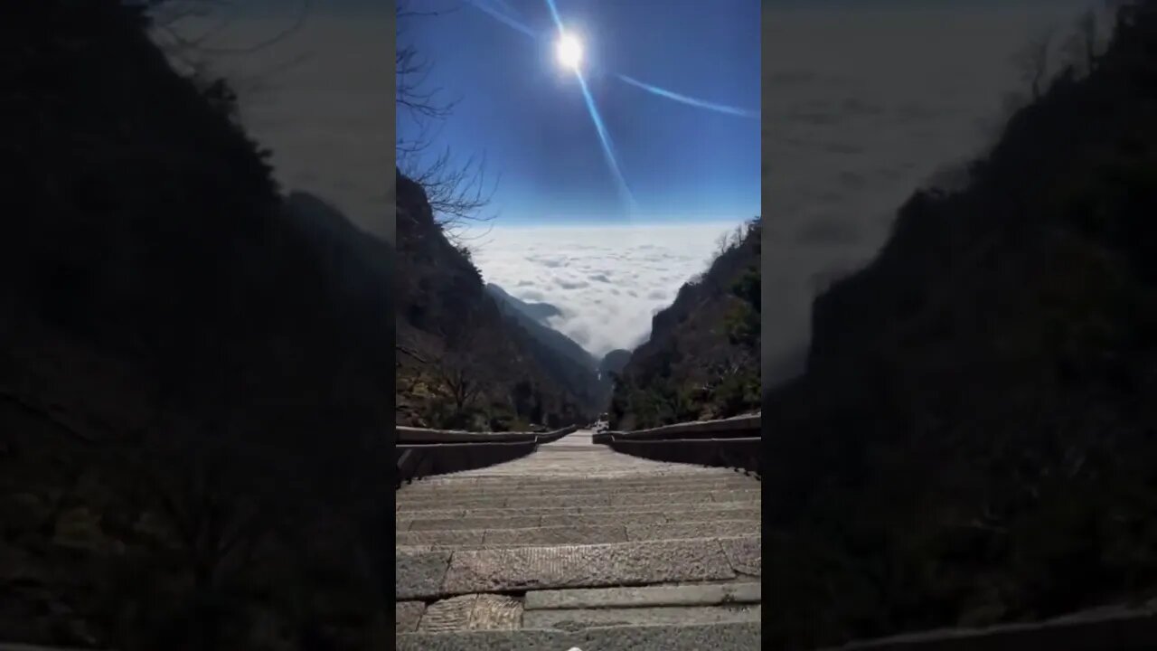 Chinese Girl Sits At The Top Of The World And Wonderers What The Trip Down Will Be Like