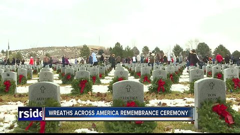 Thousands of wreaths adorn tombstones of departed veterans in remembrance ceremony