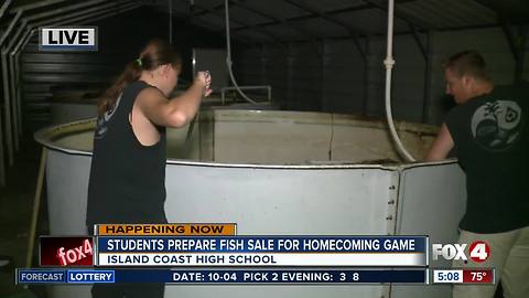 Students at Island Coast High School prepare fish to sell at homecoming game