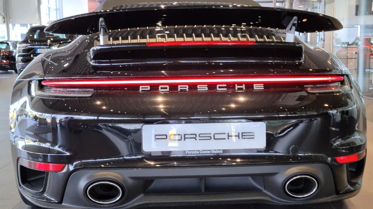 [8k] Black Porsche 992 Turbo S Convertible with Yellow seatbelts at Porsche Center Malmö