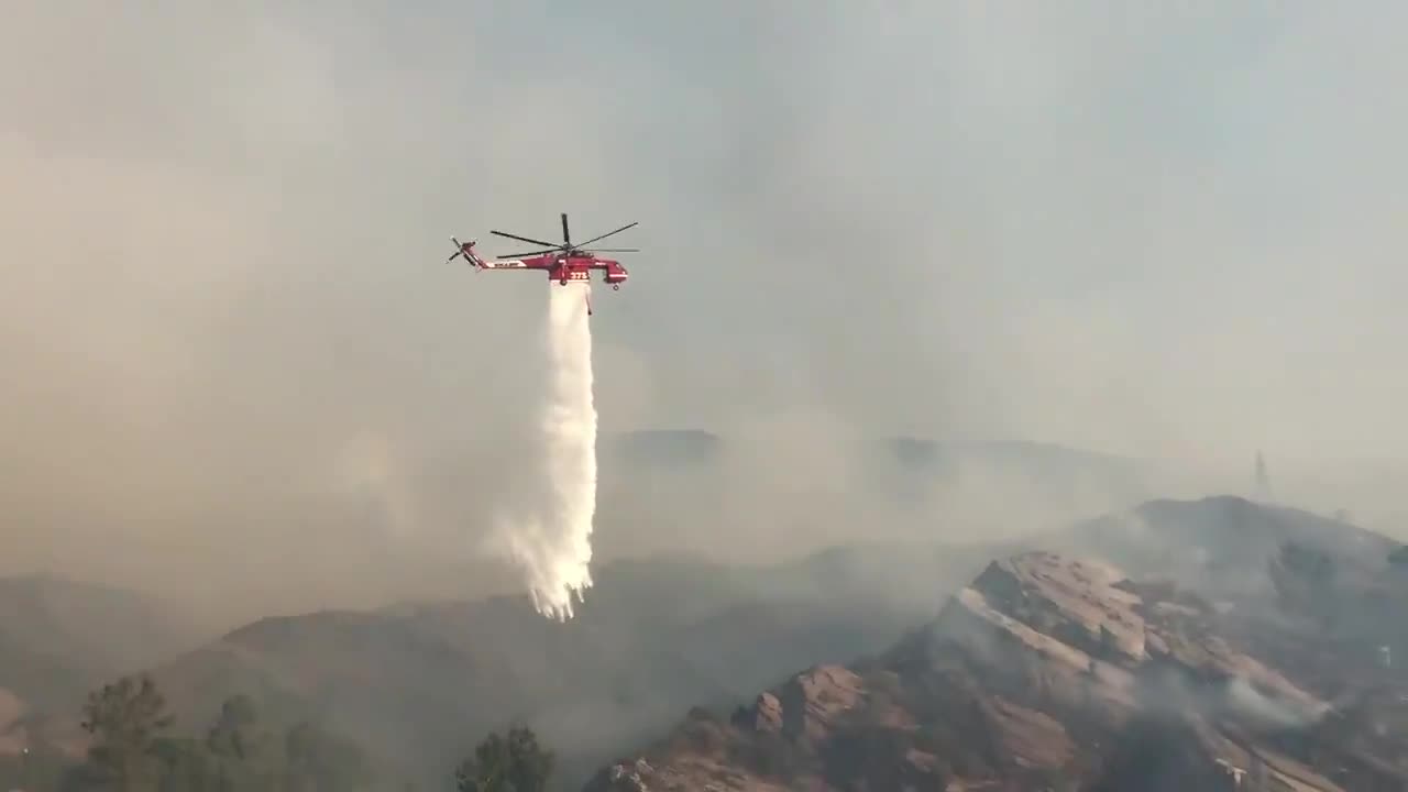 Water-dropping helicopters fight to put out Soledad Fire in California