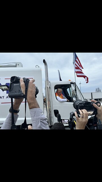 Trump adorned garbage truck tailing his motorcade.