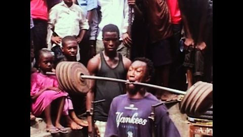 Man Weightlifts With Teeth