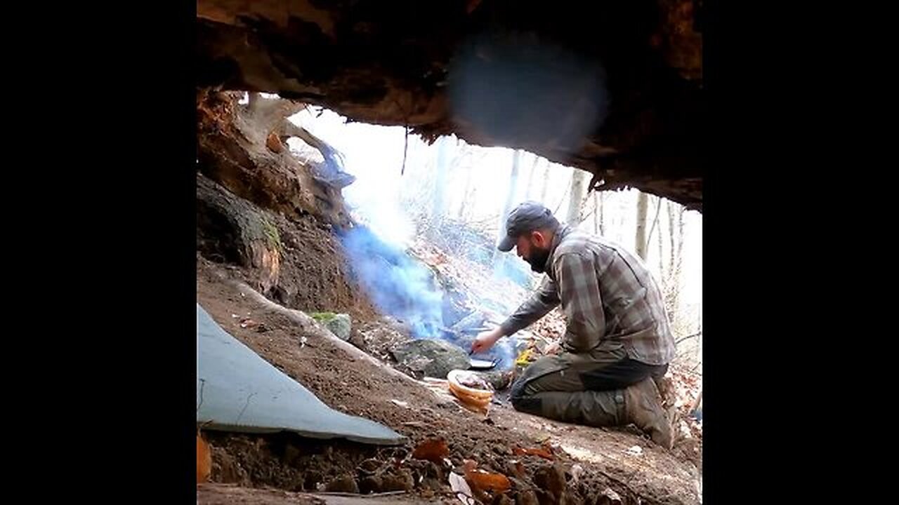 Wilderness cooking with my dog at my primitve bushcraft shelter