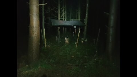 wind , light and rain test under the tarp in a woodland