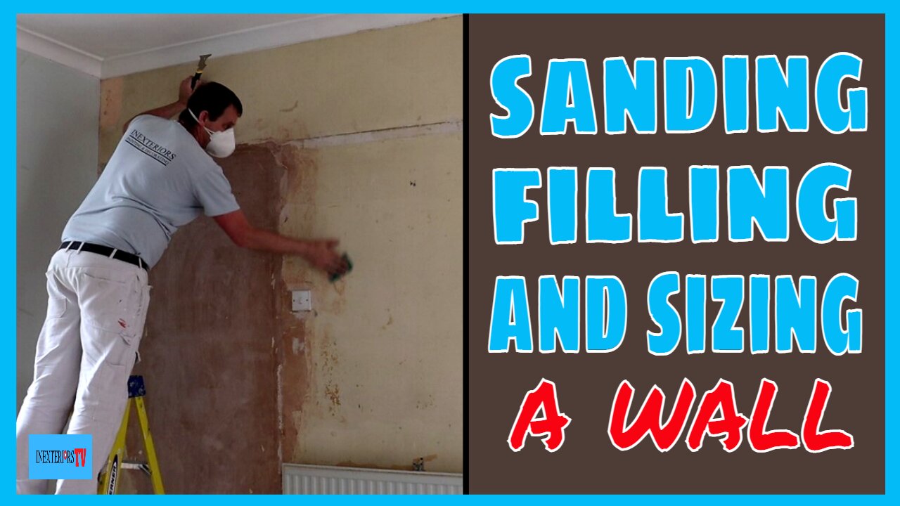 Sanding, filling, and sizing a wall.