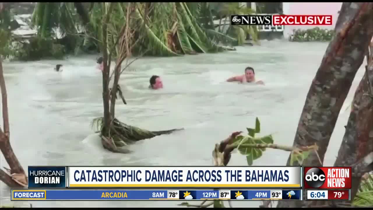 Current sweeps Bahamas residents down flooded street in aftermath of Hurricane Dorian