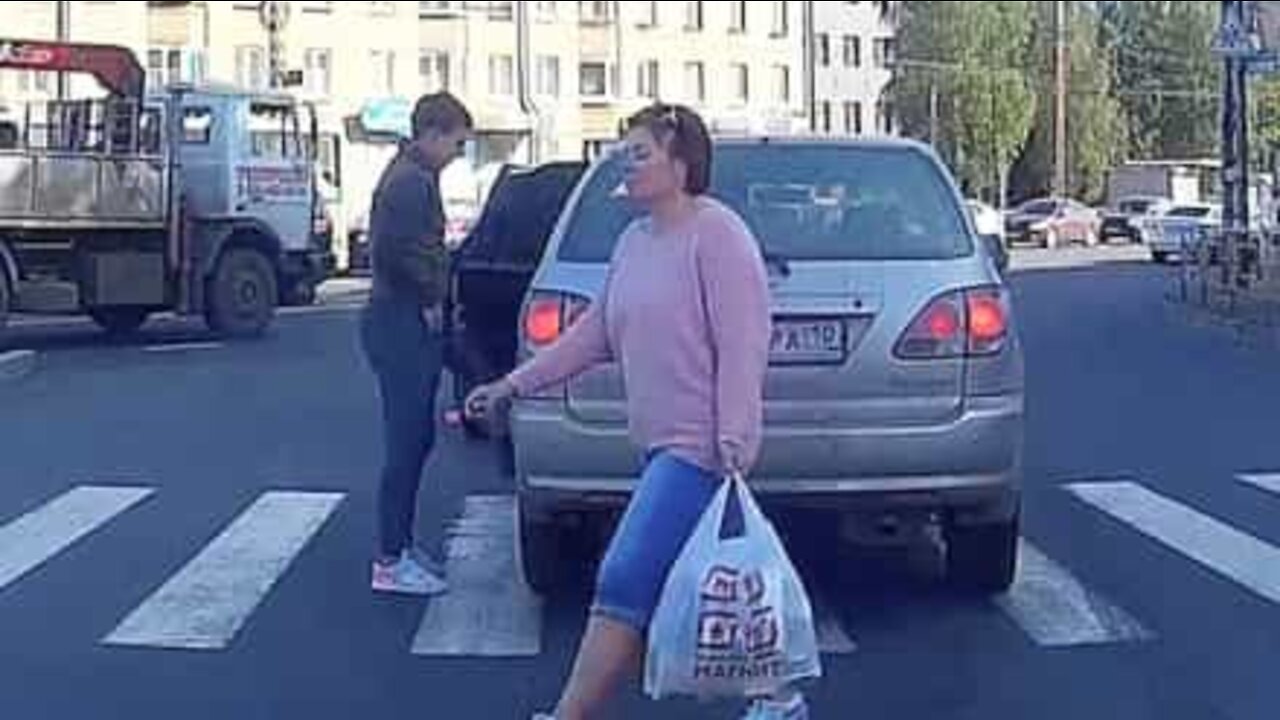 Man walks through car that's blocking zebra crossing