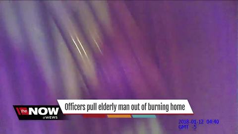 Officers pull elderly man out of burning home