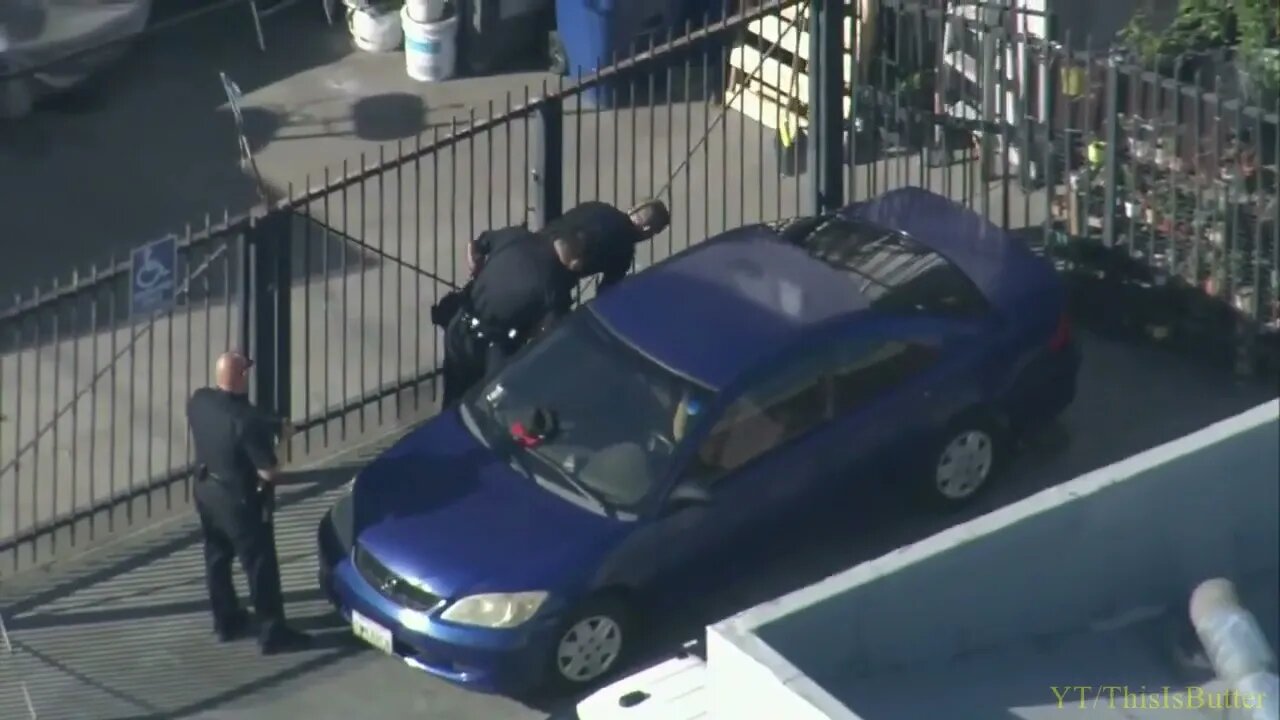 Pursuit suspect tries to evade LAPD by laying next to vehicle