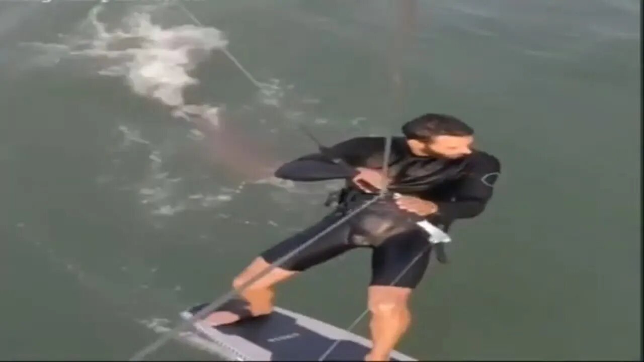 Shocking moment shark CHASES kiteboarder and viciously snaps at his board in terrifying video
