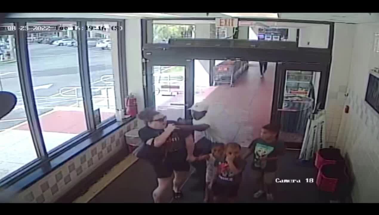 Surveillance video shows man attack woman in front of her 3 children