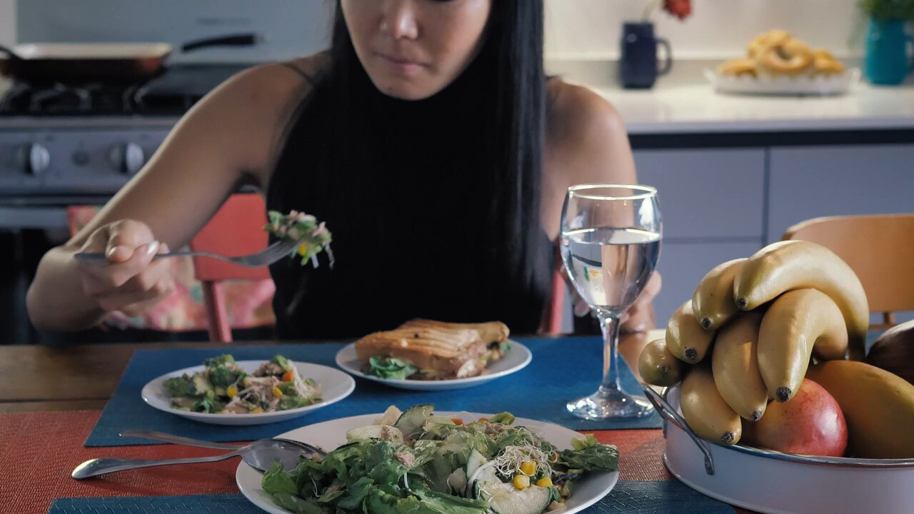 #Girl eating salad in her kitchen dining room#