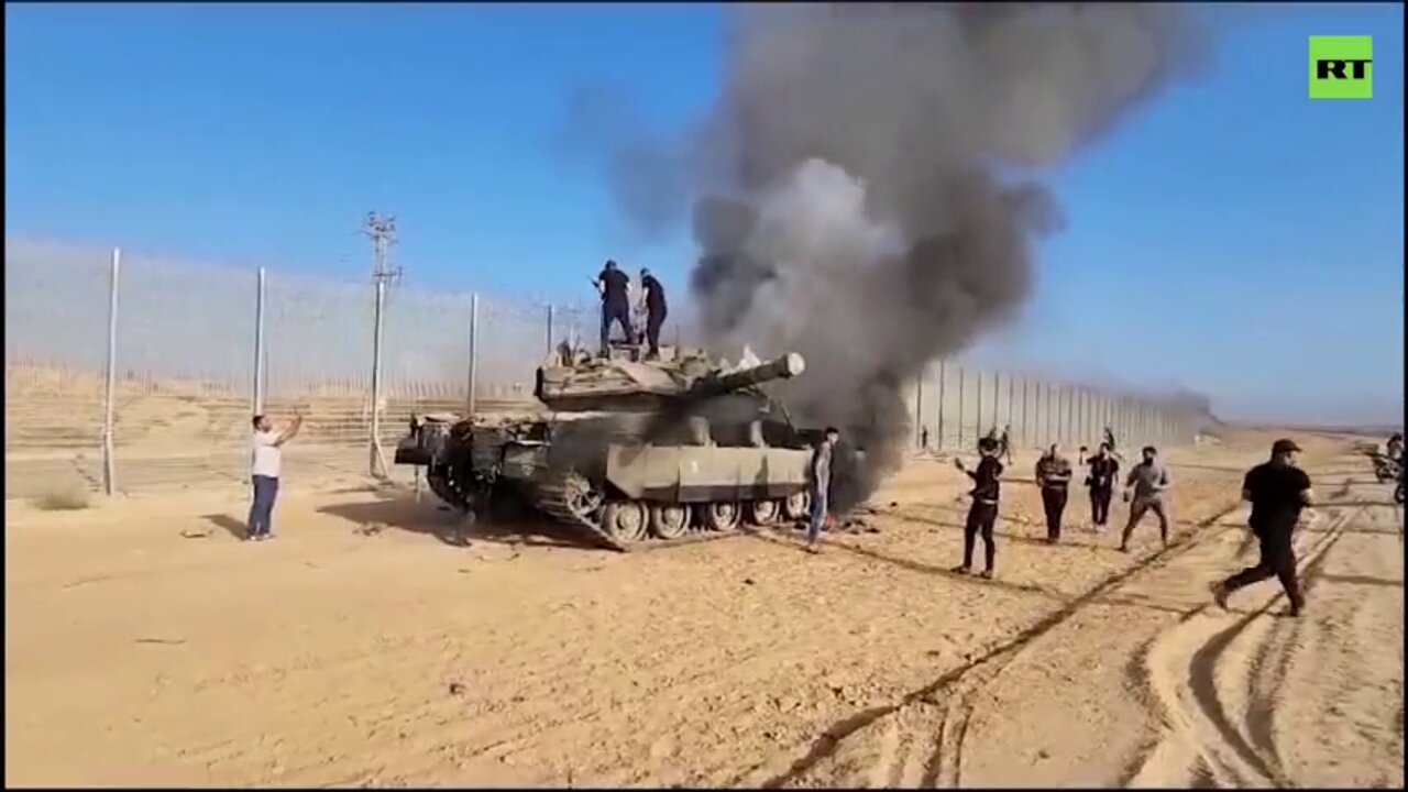 Israeli tank on fire as Palestinians cross border in the south of the country