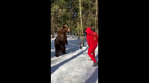 Guy playing Soccer with Bear