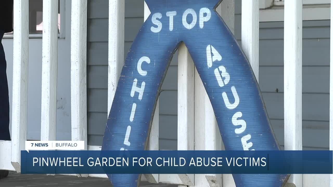 Community members plant pinwheels for child abuse victims and survivors