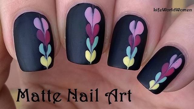 Matte black nail art idea with heart design