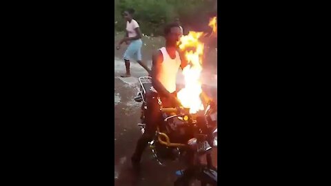 Guy riding a motorbike on fire