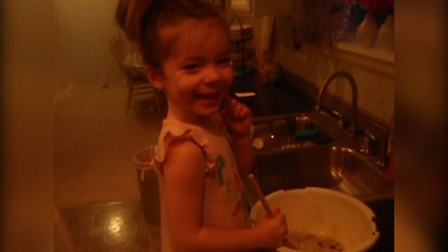 Little Girl Adds A Special Ingredient Into Muffins