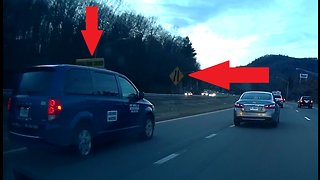 Passenger van almost runs off road trying to merge