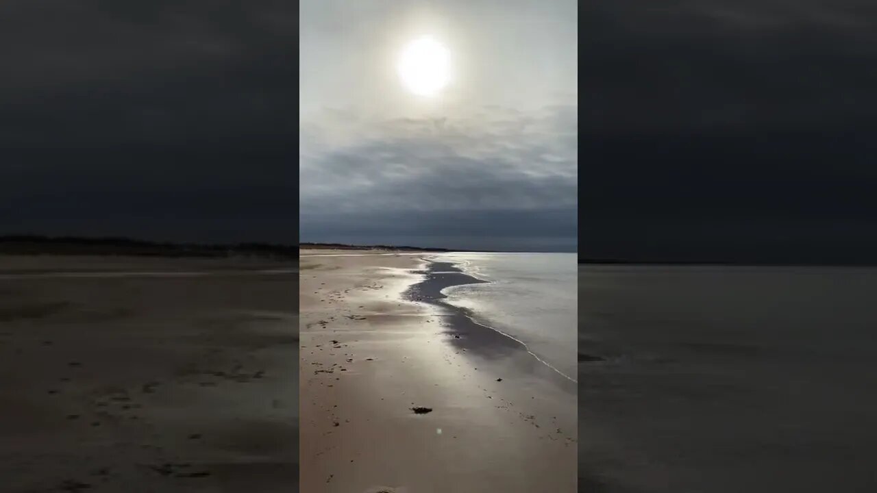 Sun through the clouds at the beach