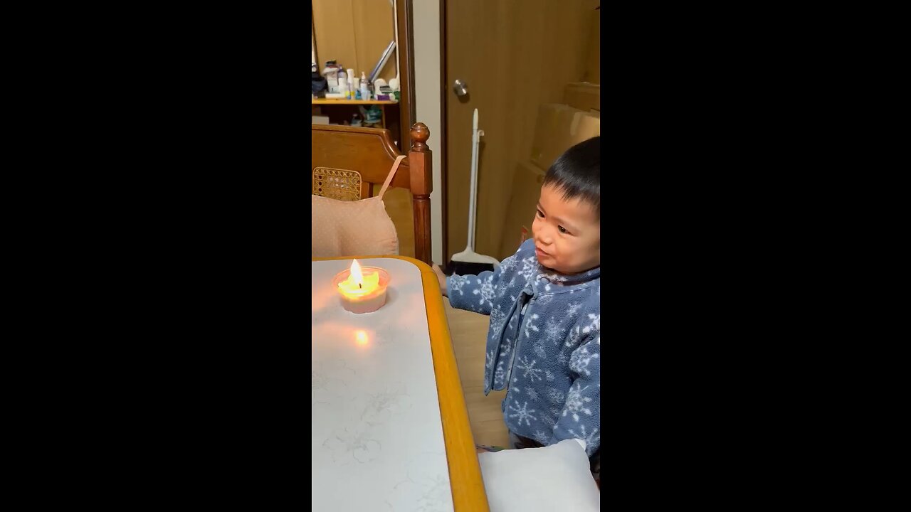 Child blowing out a candle in Japan