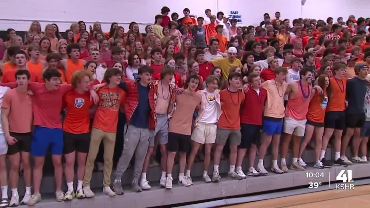 Shawnee Mission East students wear orange during home basketball game, support Olathe East peers