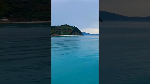 The island #sea #green #rain #clouds