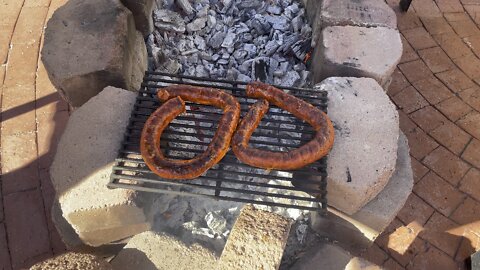 bbq pork ribs and chorizo over bed of hot coals