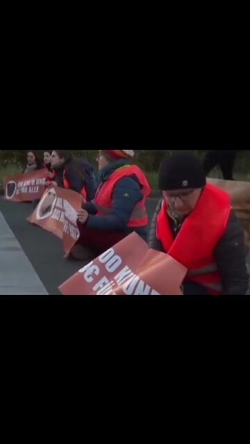 Socialist climate activist throwing plastic into gully cover.