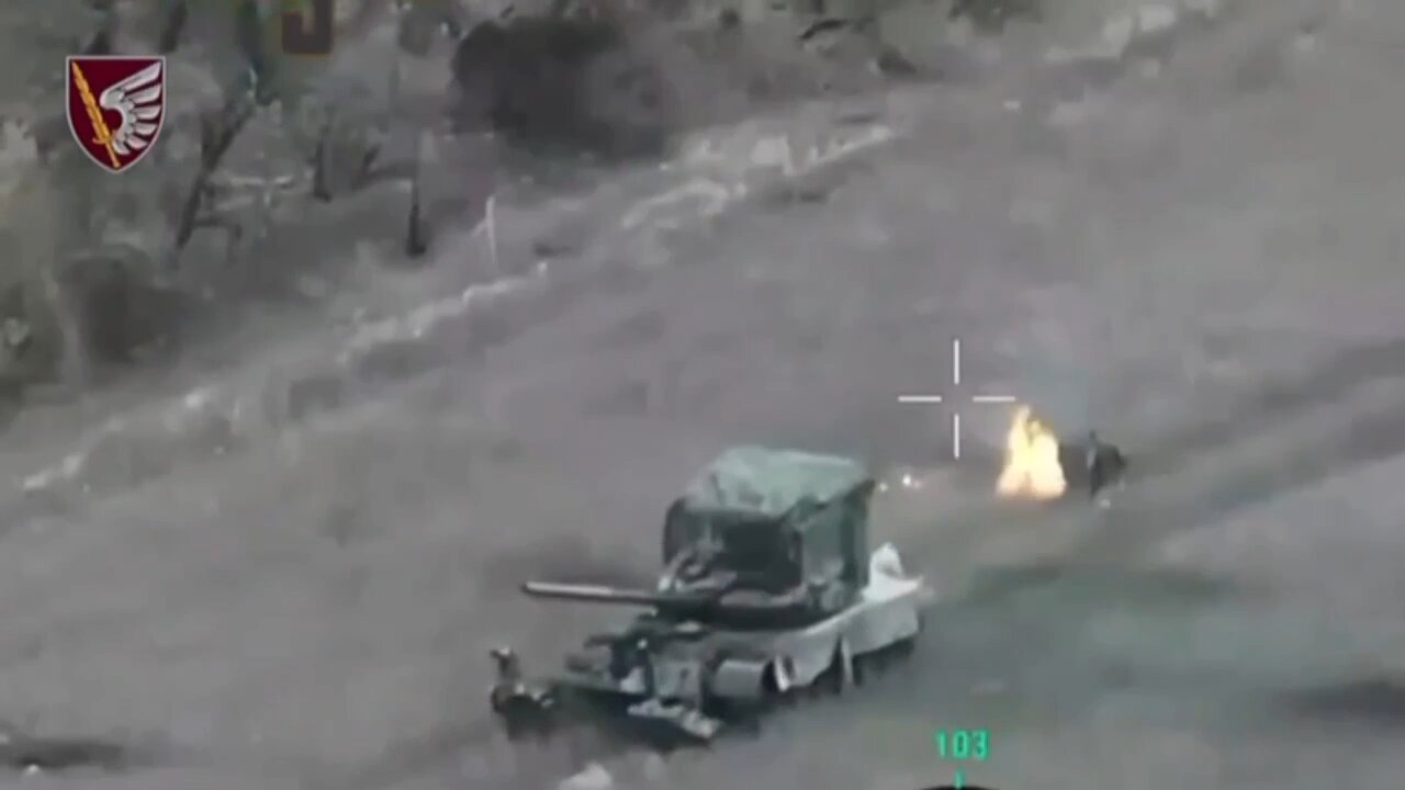 A burning Russian tanks driver jumps out of his T-80BV tank after Javelin strike