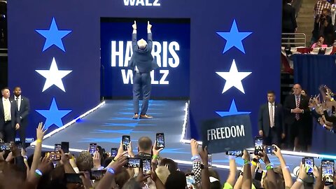 Tim Walz making his way to the crowd, displaying a series of unusual gestures reminiscent of a clown