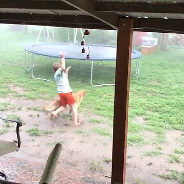 Kid Races Into Monsoon To Jump On Trampoline