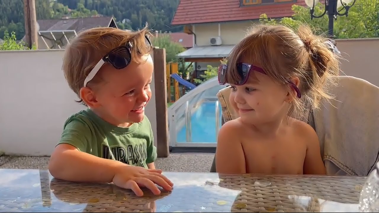 Sweet boy showers little girl with kisses