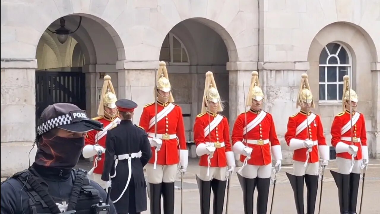 Masked police watch over 4 o'clock parade #horseguardsparade