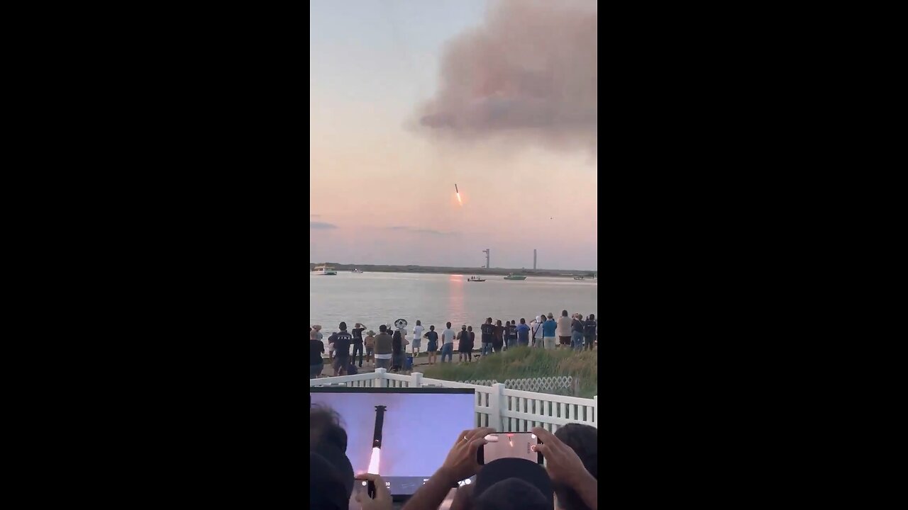 Spectators erupt in cheers as the SpaceX Starship rocket booster flawlessly returns to the launchpad