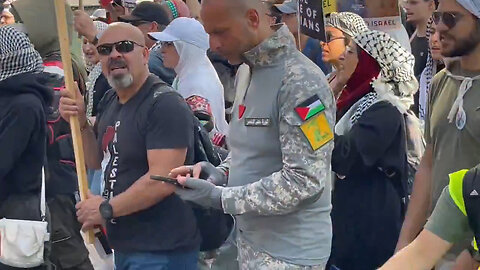 Man Outside Of The DNC Dressed In Full Military Gear With A Hezbollah Patch On His Arm