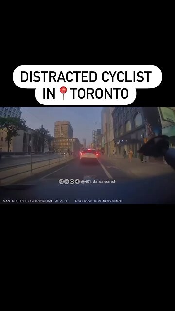 Distracted Cyclist In Downtown Toronto