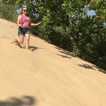 Girl Runs Down Sandy Hill But Then Falls At The End