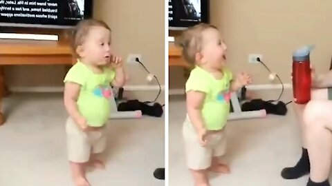 Baby can't stop laughing when he sees his mommy trying to open the bottle