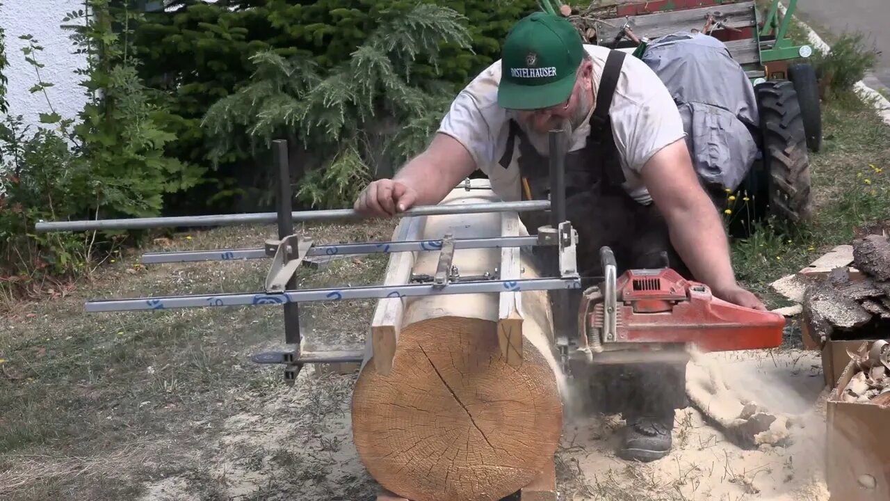 sawing a log with an alaska sawmill