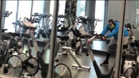 Man doesn't know how to use exercise bike