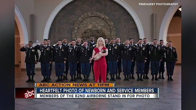 Newborn of fallen hero held by soldiers her father fought alongside in Afghanistan