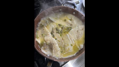 FILLET OF SOLE IN A BUTTER SAUCE WITH CAPPERS ON A BED OF RICE
