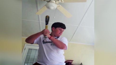 Funny Young Boy Breaks A Light Bulb With A Bat