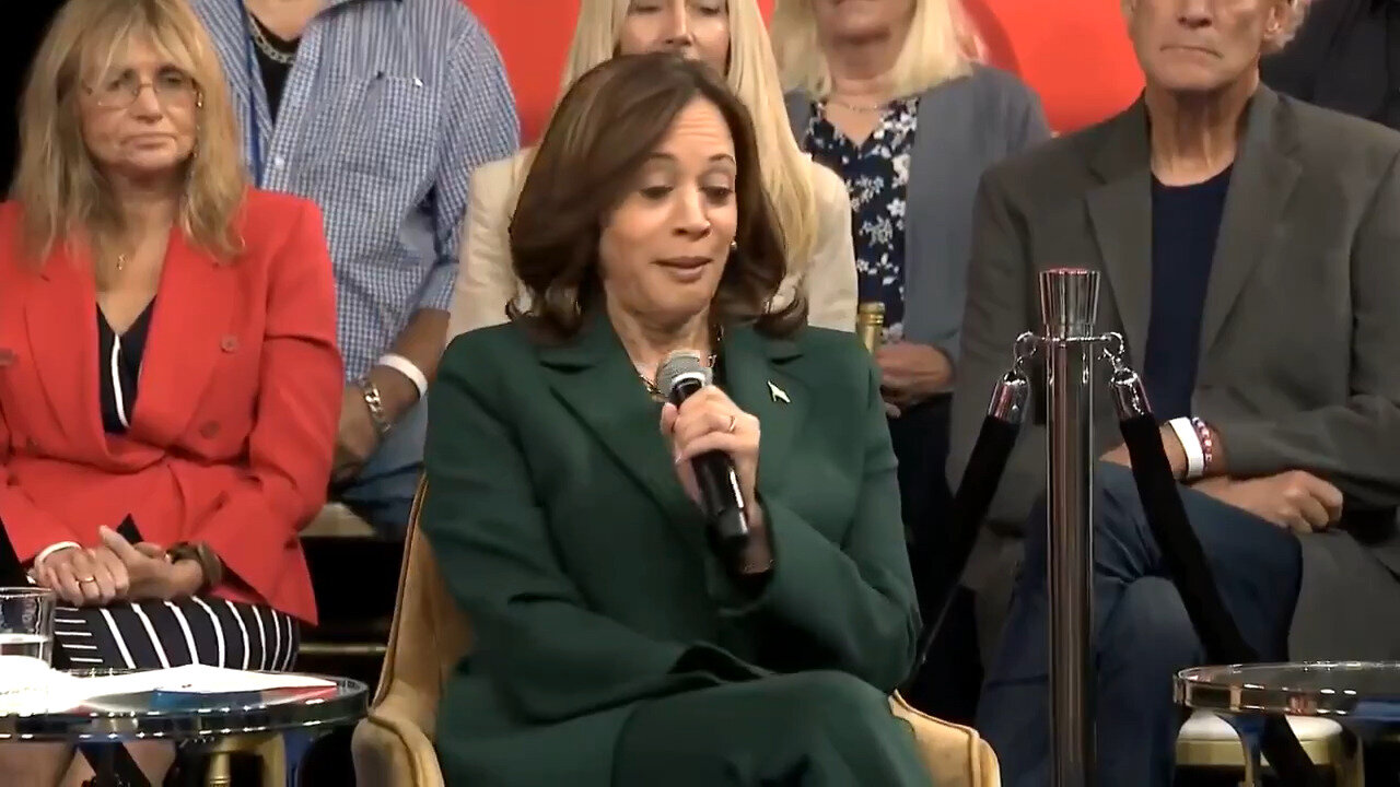 Make It STOP! Look On Man's Face Behind Kamala As She Rambles About … Something Is PRICELESS