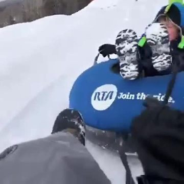 Kids sledding in the snow