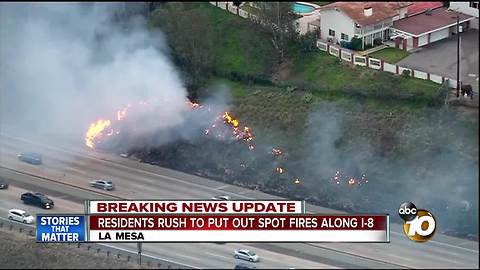 Residents rush to put out spot fires along I-8