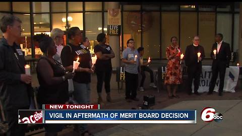 Demonstrators hold vigil after Merit Board decision not to fire officers